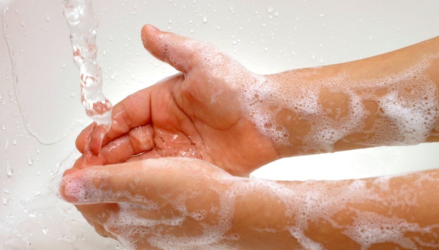 Young child washing hands with soap