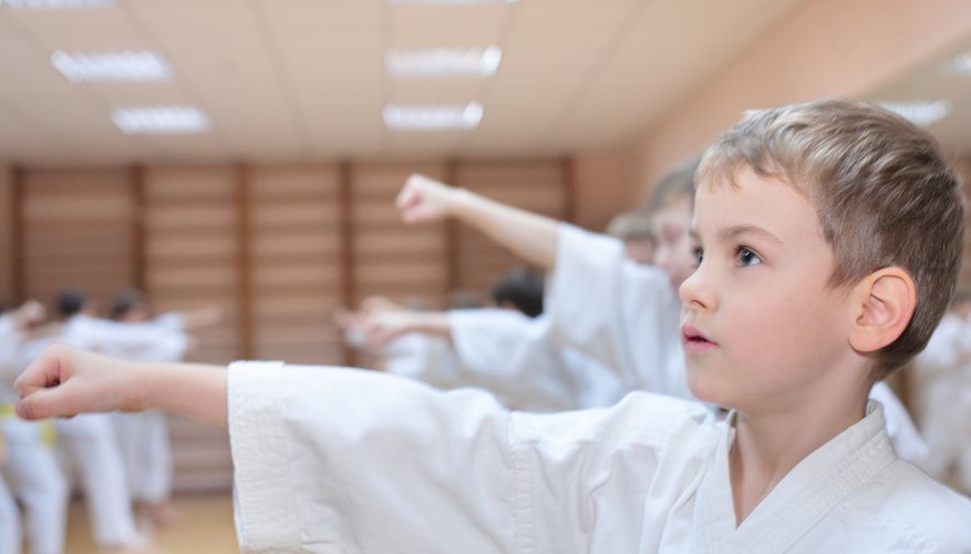 Boy punching at martial arts class.