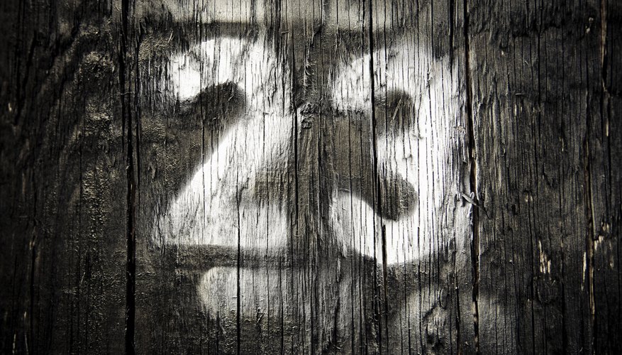 The number 23 spray painted on a wooden fence.