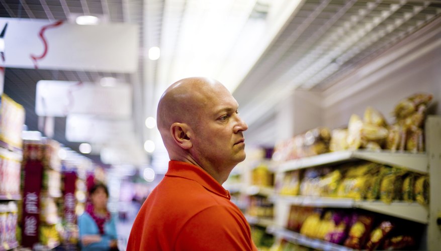 A man is shopping in a grocery store.
