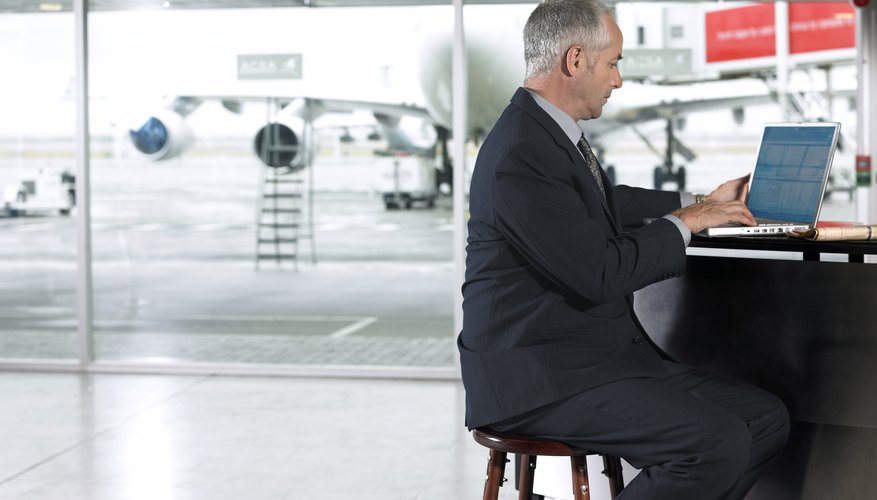 A businessman is typing a letter.