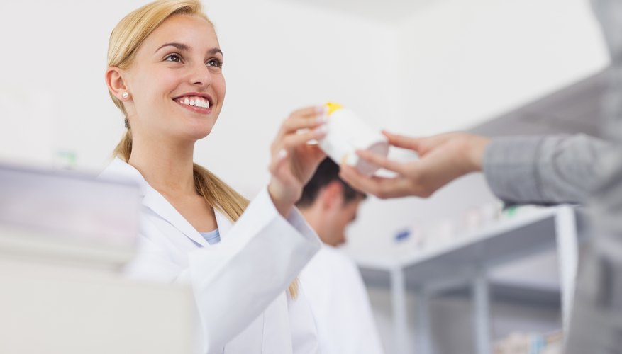 A pharmacist giving drugs to a patient.