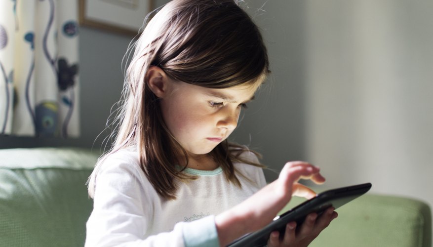 A child uses an software app on a tablet computer.