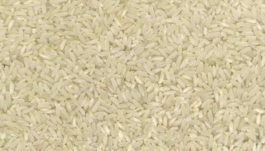 Use measuring cups to fill storage containers with rice.
