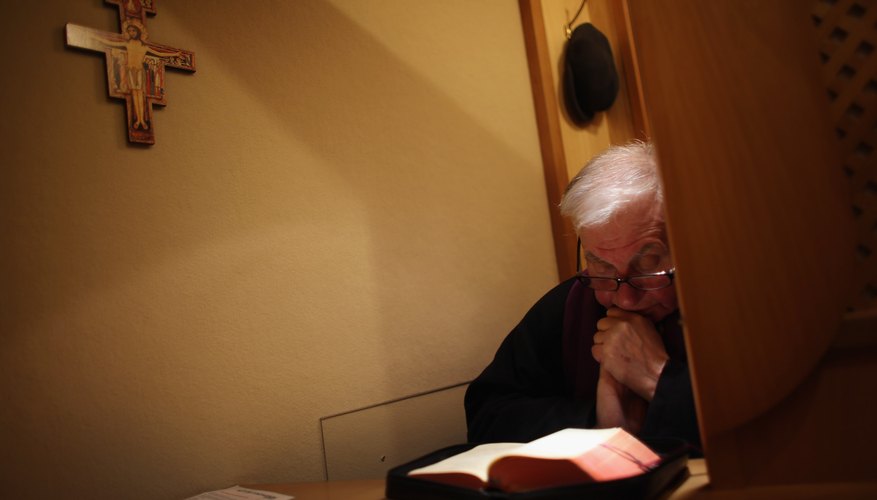 Friar at confession, where Catholics go to have sins forgiven.
