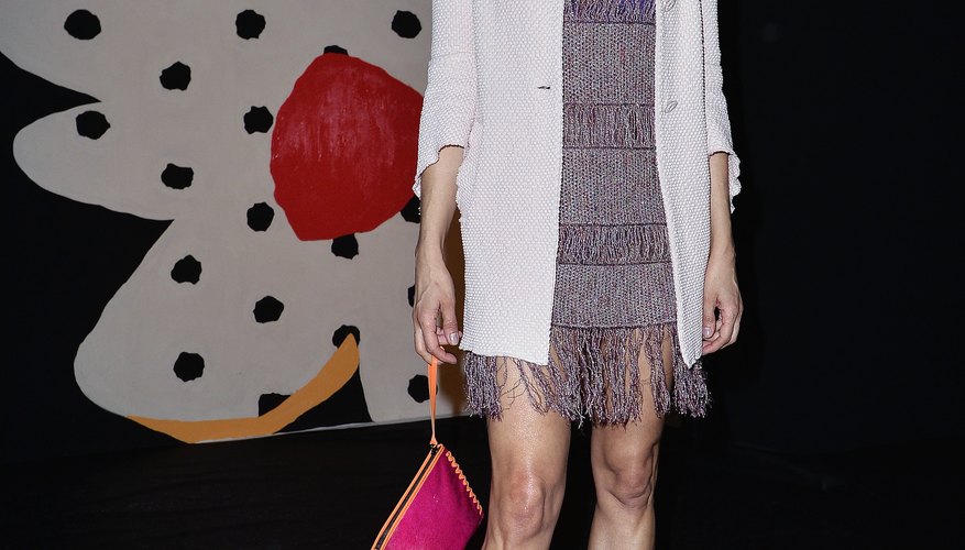 Model Nadege Dubospertus pairs her short grey dress with bright blue platforms.