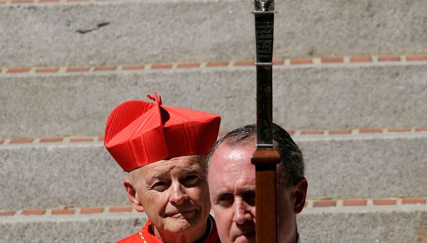 The Catholic archbishop of Washington awaits the arrival of the deceased's body from the vigil site.