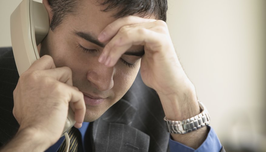 Man listening on a telephone.