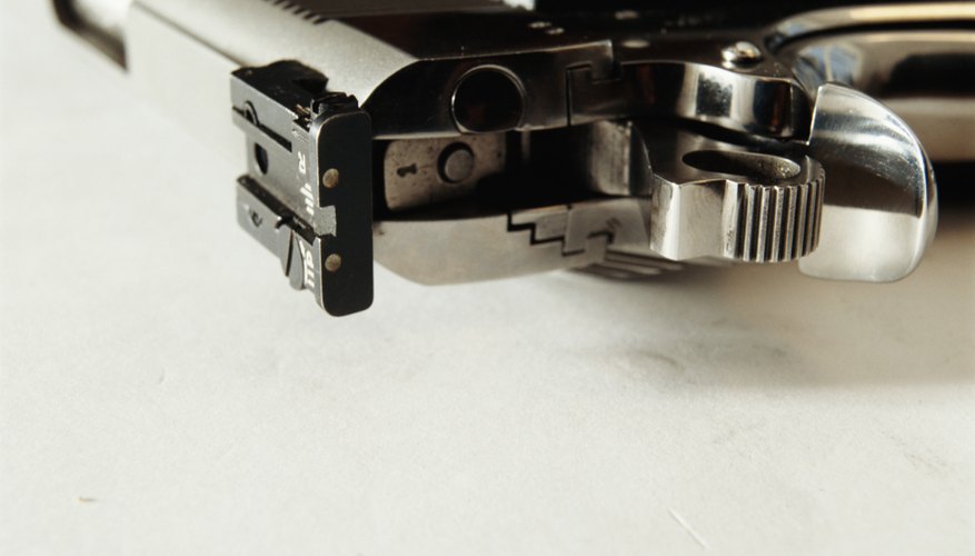 Photo Credit: David De Lossy/Photodisc/Getty Images Back of handgun, closeup