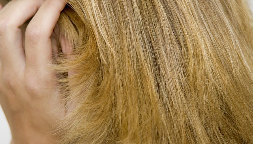 Add shine and definition to a layered cut using a flat iron.