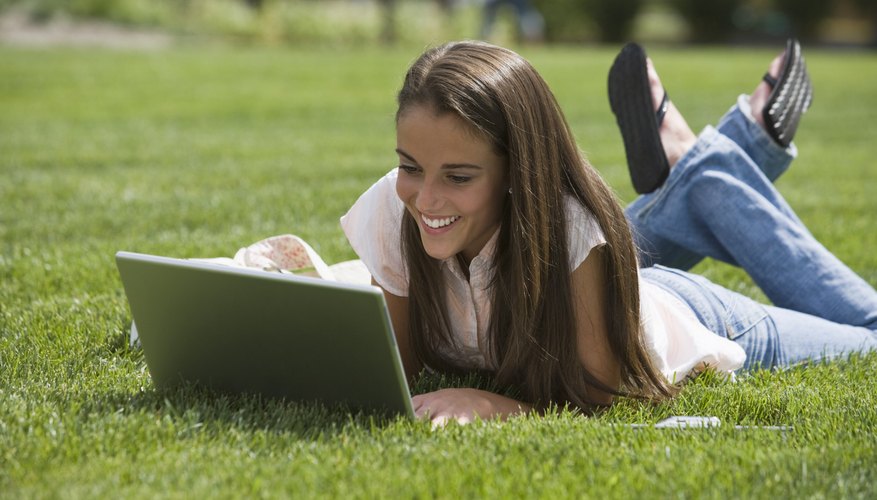 Student filling out online application on laptop