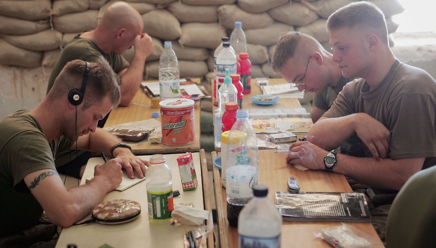 U.S. Marines read and write letters during a break in their barracks in Iraq.