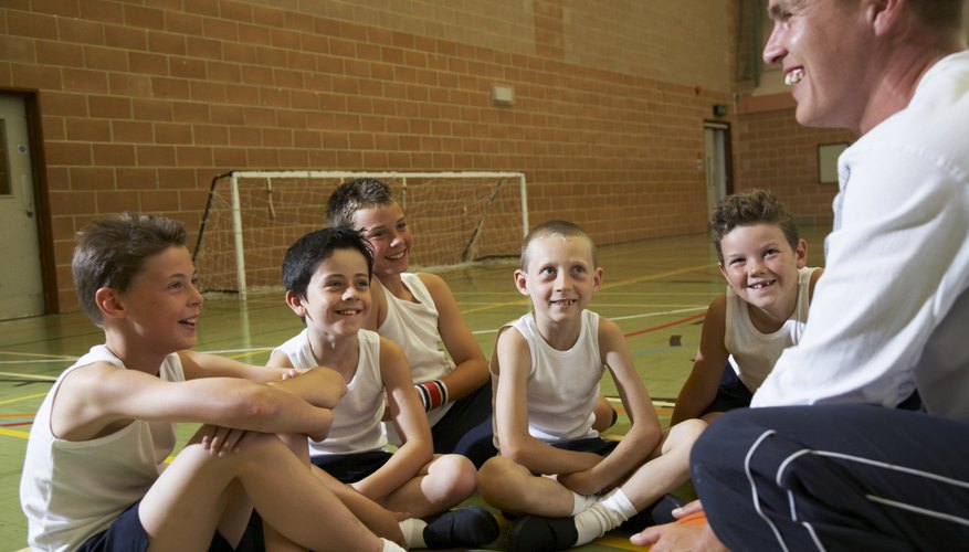 Boy sitting around PE teacher