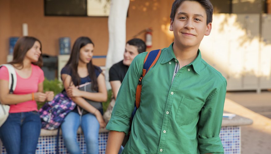 Junior high students talking to each other on campus.