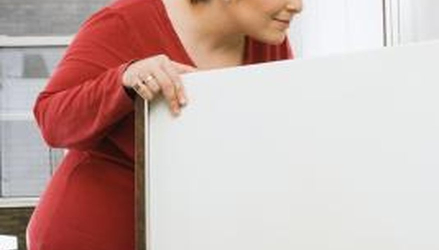 Investigate the cause of chemical odours in a refrigerator as soon as possible.