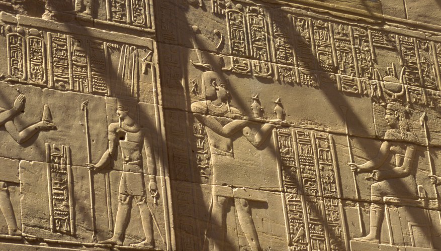 Egyptians carved both hieroglyphics and symbols into walls in places of power, like palaces and tombs.