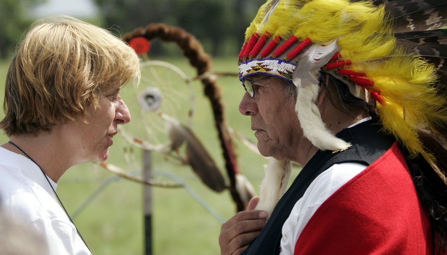 Dennis Banks, a founder of the American Indian Movement, in headdress, meets with a political activist.