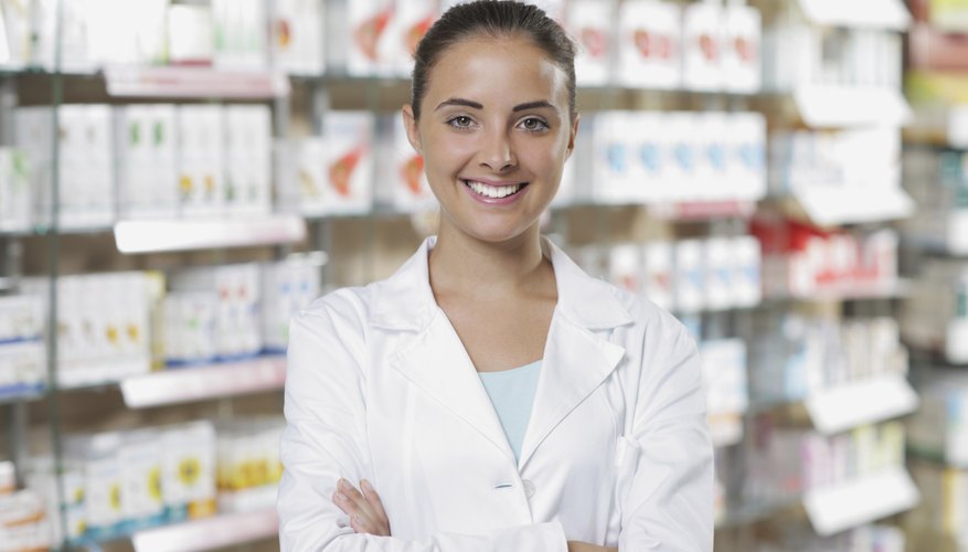 A pharmacist standing in front of medication shelves