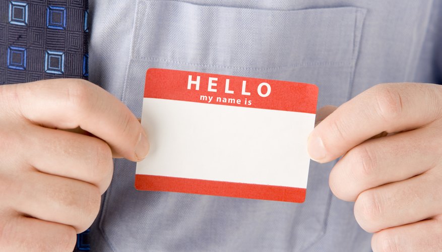 A man holds a blank name tag.
