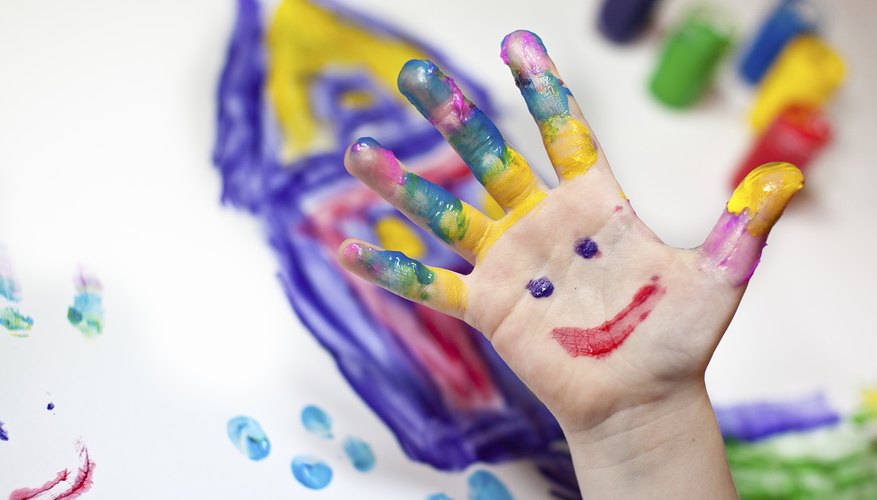 A young student fingerpainting.