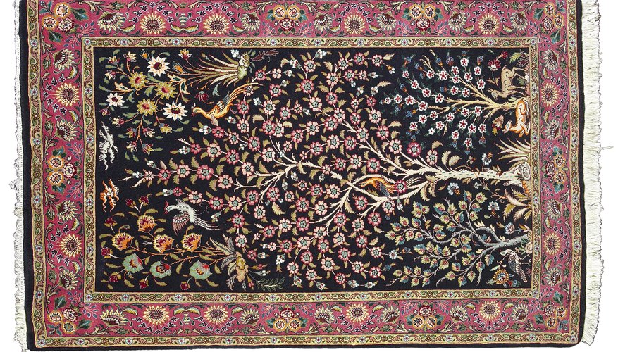 A Mughal carpet with naturalistic vegetal patterns and mille-fleur design.