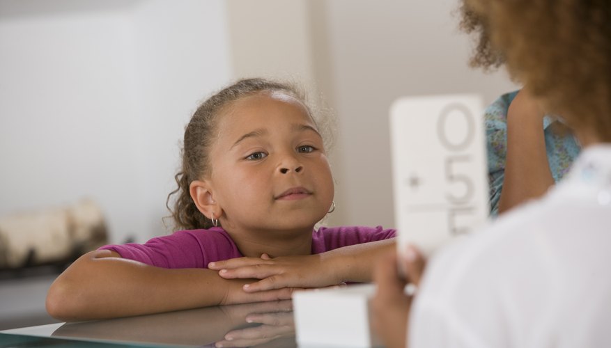 Young child practicing her math skills with flashcards.