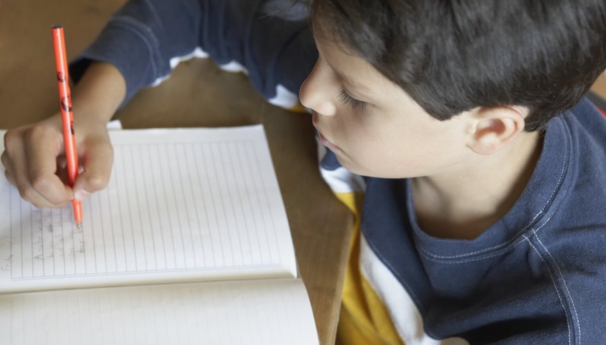 Child writing in notebook.