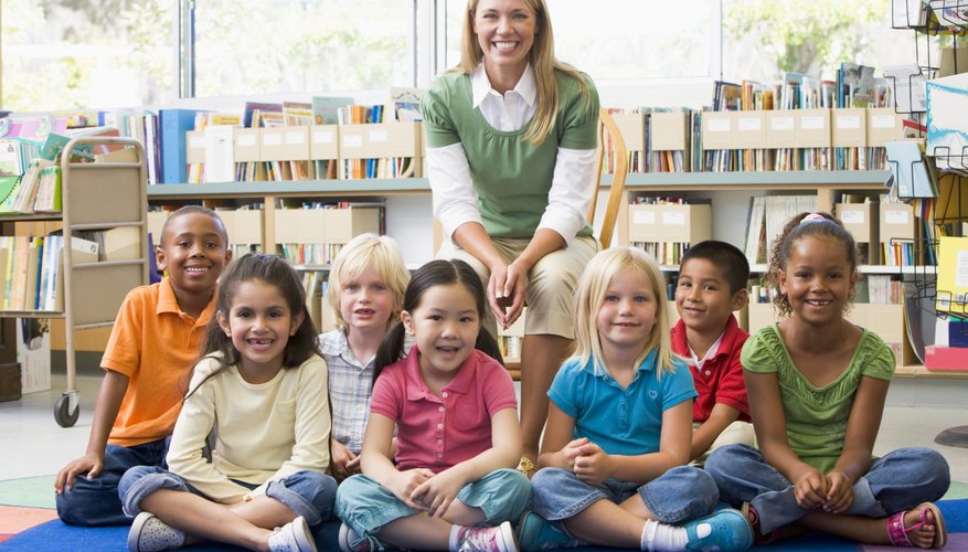 Smiling teacher and preschoolers in classroom