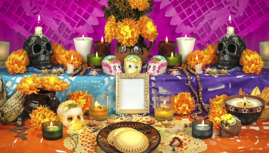 Day of the Dead altar with flowers, candles and skulls