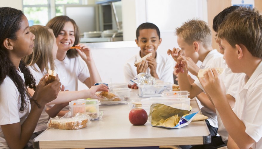 School children eating lunch in the cafeteria.