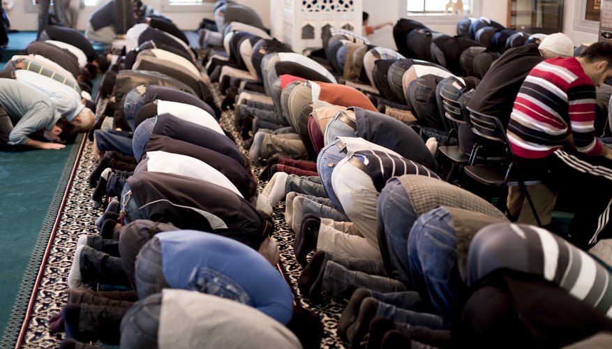 Muslims kneel on prayer mats, called