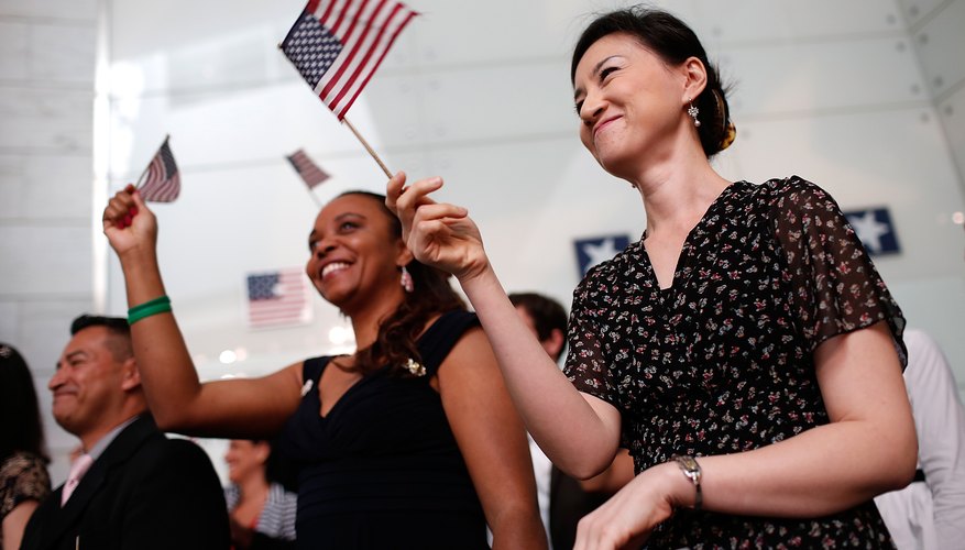 Patriots waving flags at a ceremony.