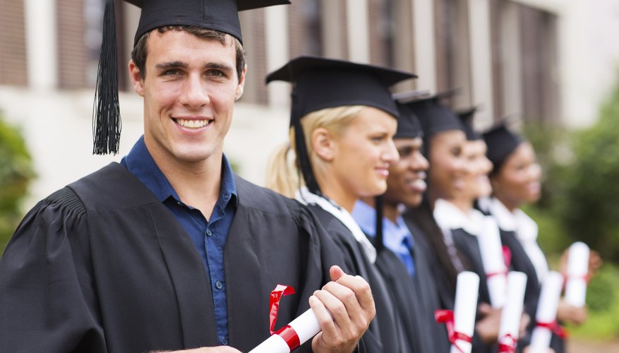 Smiling graduate student holding diploma