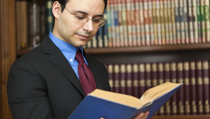 Lawyer reading from legal book