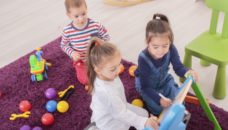 Preschoolers drawing together in classroom