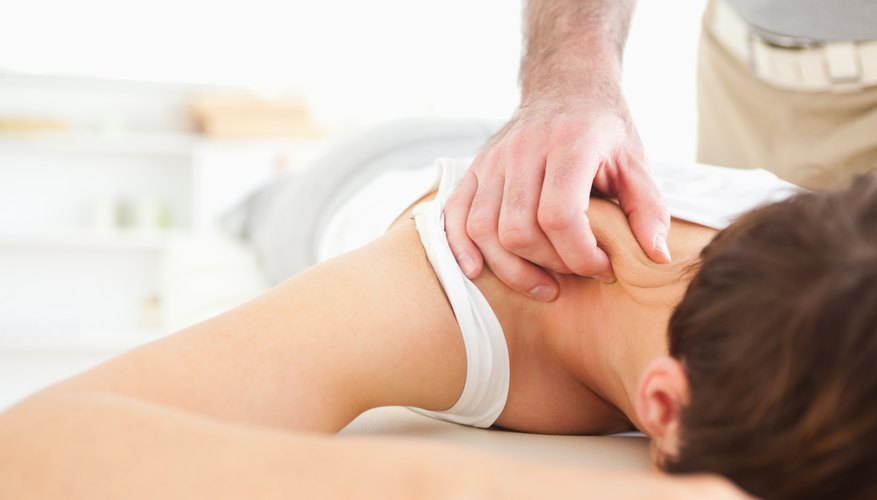 A close-up of a therapist applying pressure to a patient's neck.