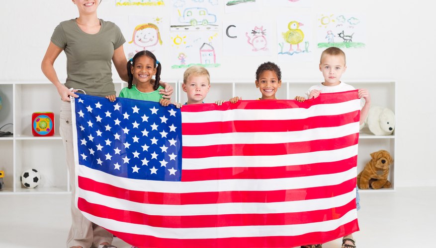 Teacher and students holding an American Flag.