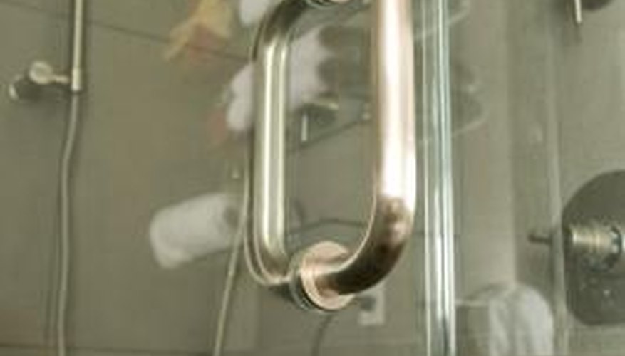 Many shower doors have metal hinges that swing the door in and out.
