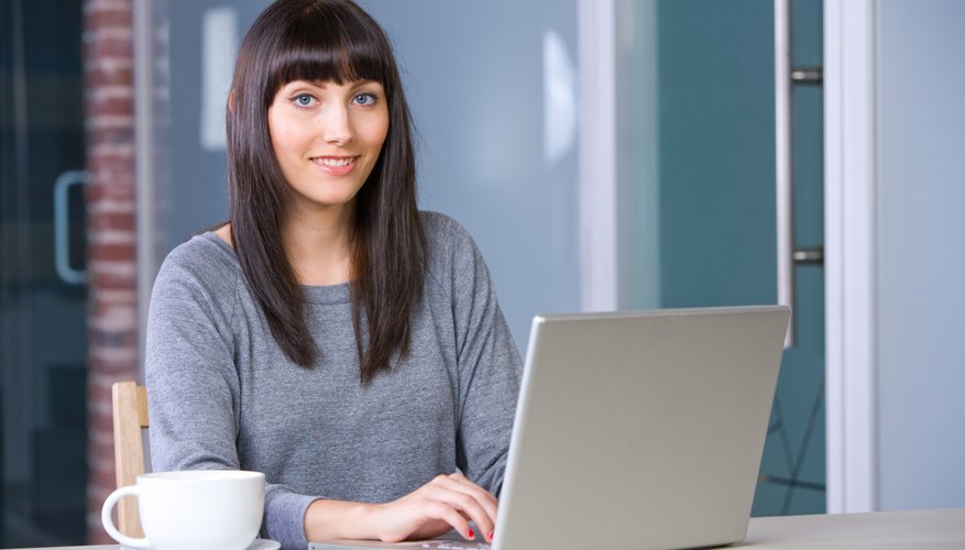 Young woman doing research on laptop