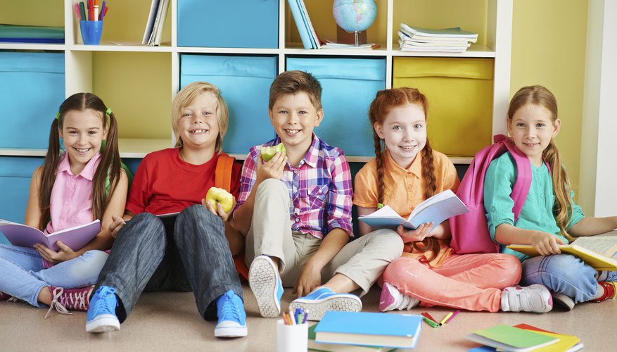 A group of students enjoy reading books while on lunch period.