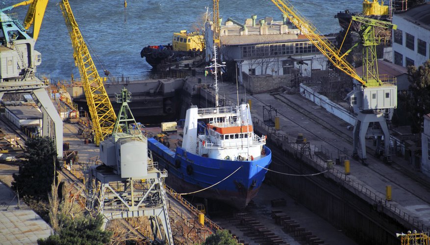 A ship is getting repaired in a dry dock.