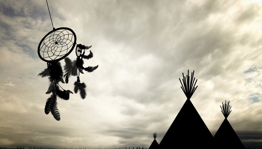 A dream catcher next to some teepees.