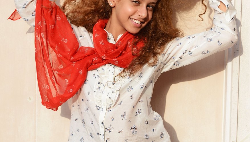 Actress Waad Mohammed rocks a blue-and-white print shirt with a tomato-red scarf in Dubai in 2012.