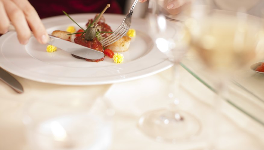 A close-up of a woman eating an appetizer in a restaurant.