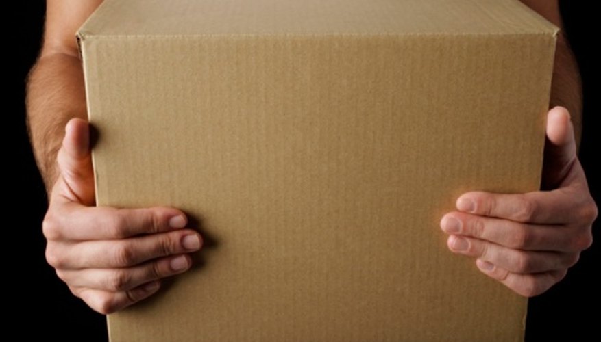 A cardboard sheet from a box makes a sturdy base for clay cannon replicas.