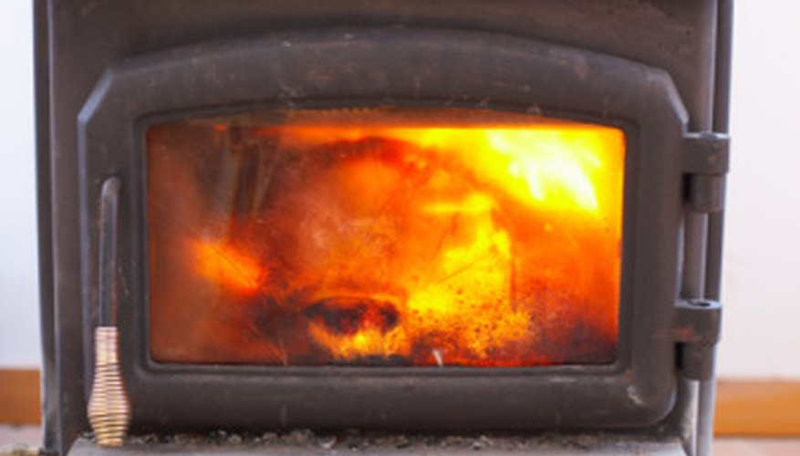 Photo Credit: Jupiterimages/Photos.com/Getty Images Smaller wood stoves may require fewer logs due to spacing issues.