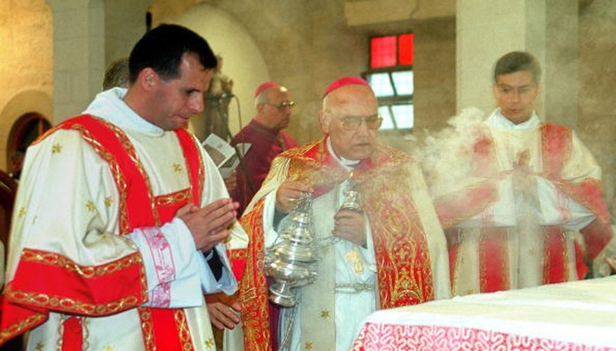 A priest in Bethlehem uses incense to bless the altar.