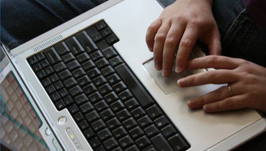 Hands type on a laptop