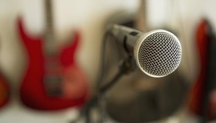 A close-up of a microphone in a room with instruments.