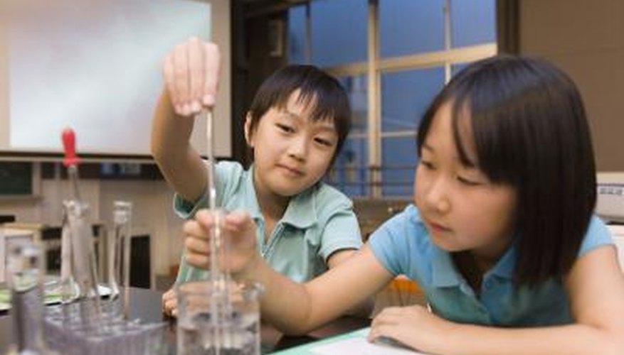 Two children conduct a test in a science lab.